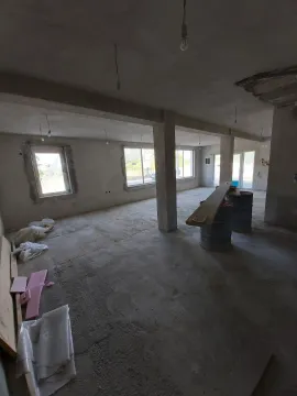 Spacious interior space in the gray phase of construction with concrete pillars. - image 6