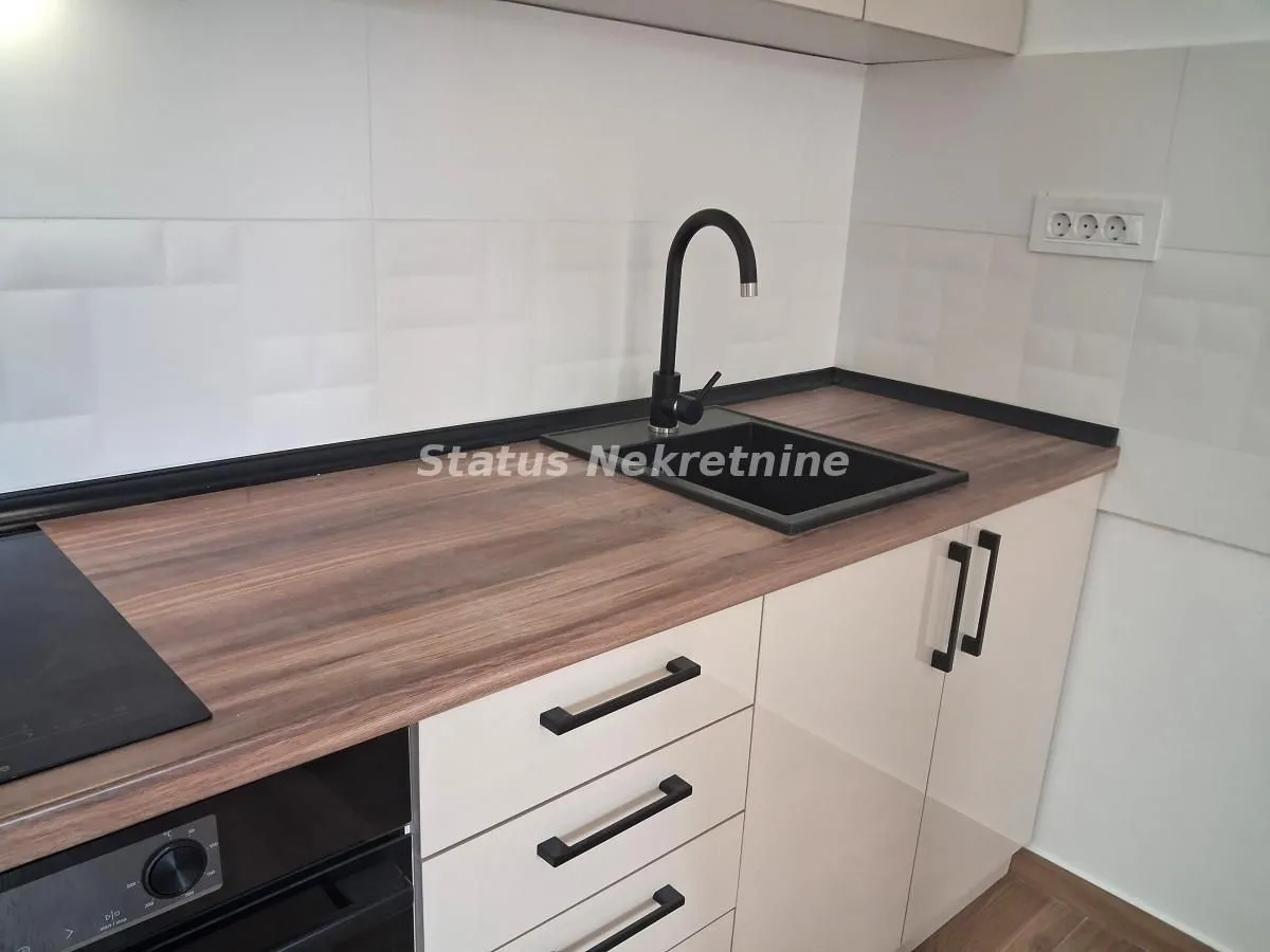 Part of the kitchen with a sink, countertop and built-in units.