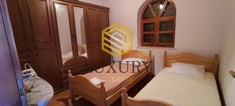 Bedroom with two wooden beds and a large wardrobe. - image 13