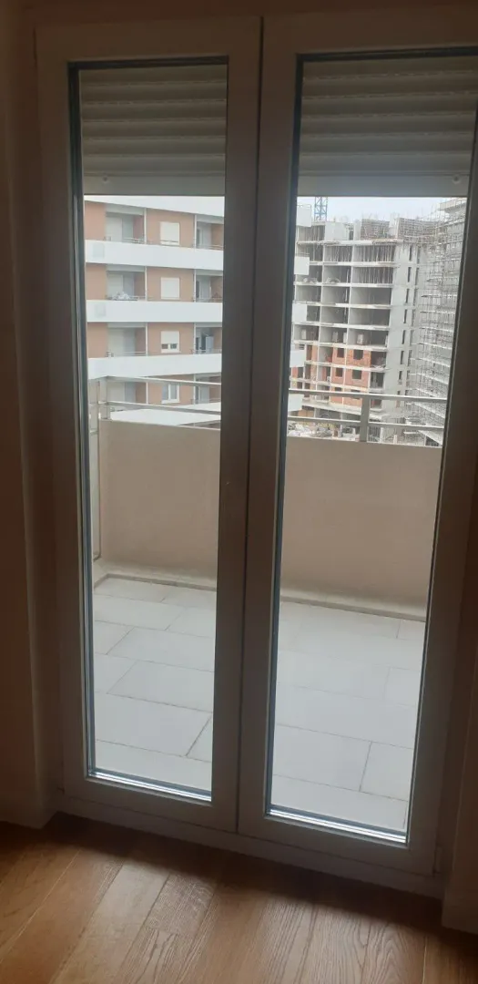 View of the terrace through the glass balcony door.