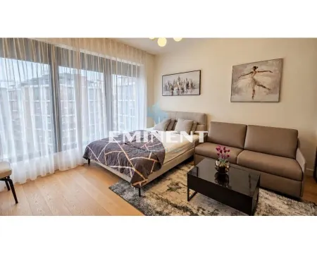 Modern bedroom with a double bed, sofa, and large window. - image 2