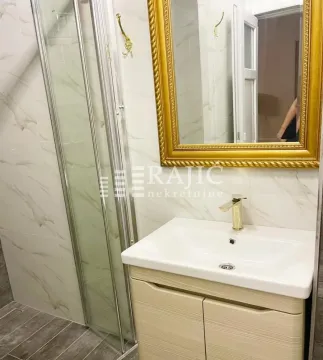 Bathroom with a vanity, mirror, and shower cabin. - image 7