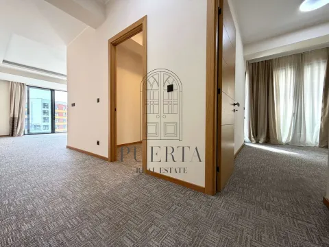 Spacious bright carpeted living room with interior wooden doors. - image 8