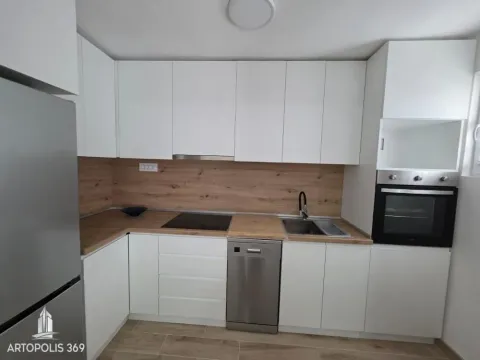 Modern kitchen with white units and wooden worktops. - image 6