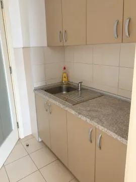 Small kitchen with a sink, countertop, and wall cabinets. - image 13