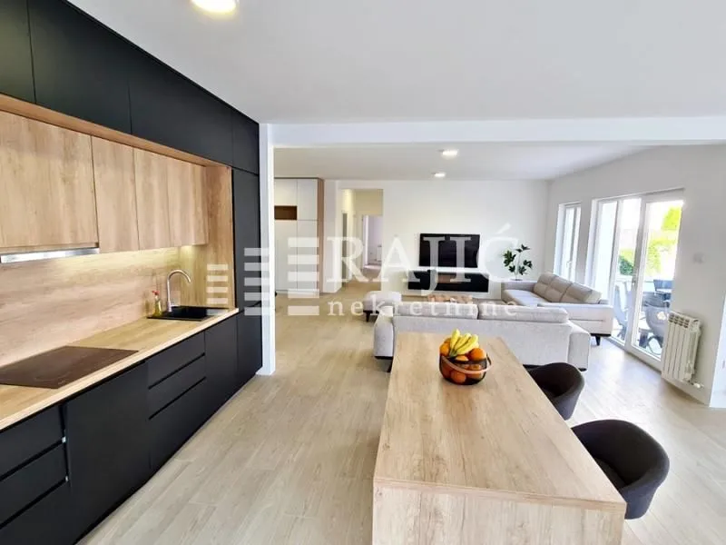 Modern kitchen connected to the dining area and living room.