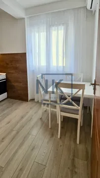 Dining table with white chairs by the window in the kitchen. - image 6