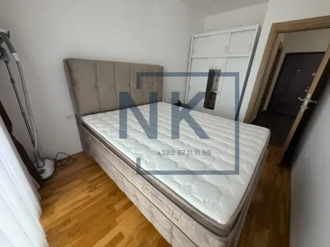 Furnished bedroom with a double bed, wardrobe, and wooden flooring. - image 5