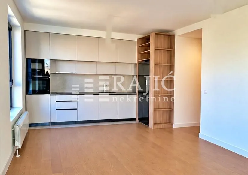 Modern kitchen with white cabinetry and a wooden shelving unit.