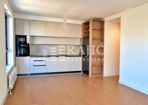 Modern kitchen with white cabinetry and a wooden shelving unit. - image 4
