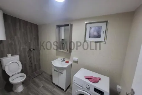 Bathroom equipped with sanitary fixtures, a sink, a mirror, and a washing machine. - image 6