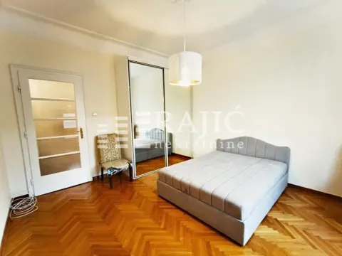 Bedroom with a double bed, mirrored wardrobe, and parquet flooring. - image 7