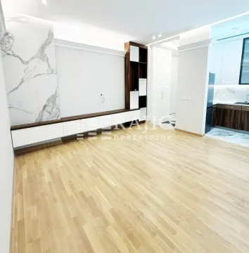 Spacious living room with hardwood floors and modern wall panels. - image 7