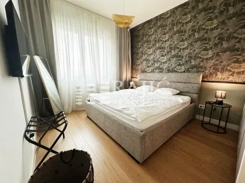 Modern bedroom with a double bed and patterned accent wall. - image 9