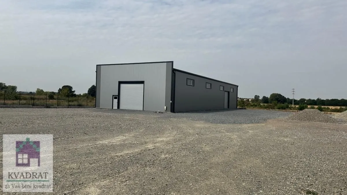 Exterior view of the commercial building with a large yard.