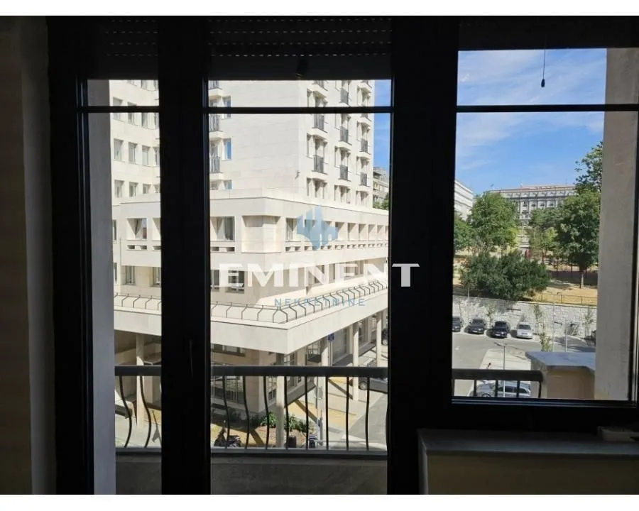View through the window of surrounding buildings and the street.