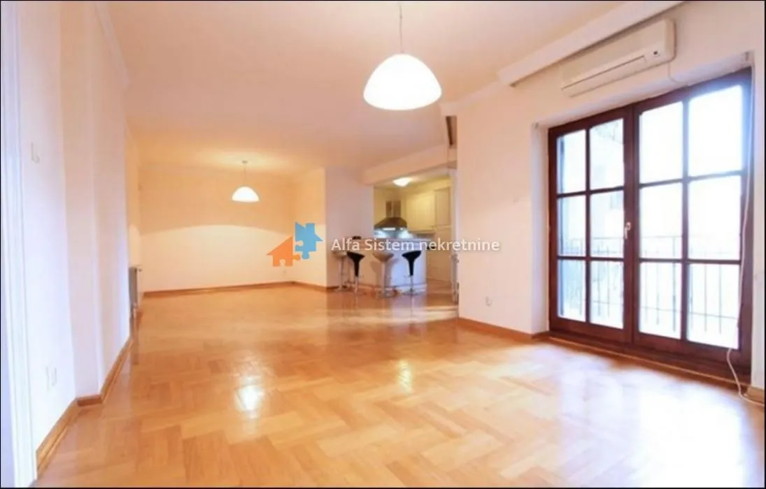 Spacious living room with parquet flooring and access to the terrace.
