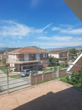 View from a spacious terrace overlooking neighboring houses and distant mountains. - image 4
