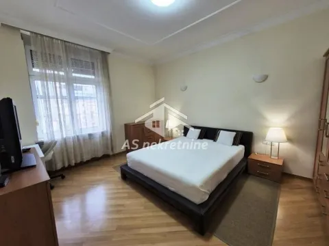Spacious bedroom with a large double bed and wooden furniture. - image 11