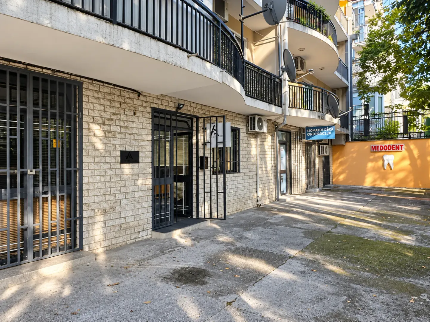 Exterior view of the commercial space with an entrance and pavement in front of the building.