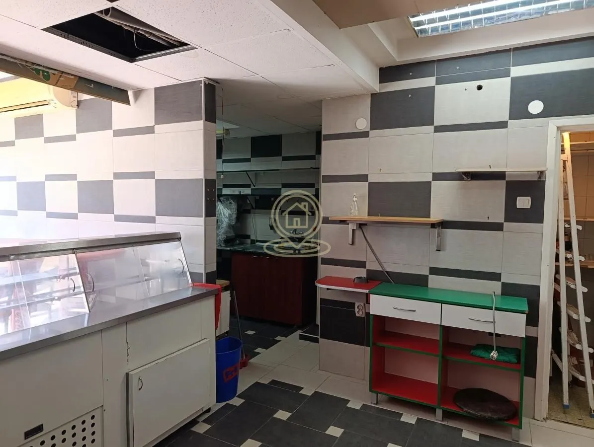 Kitchen with checkered tiles and a working counter.