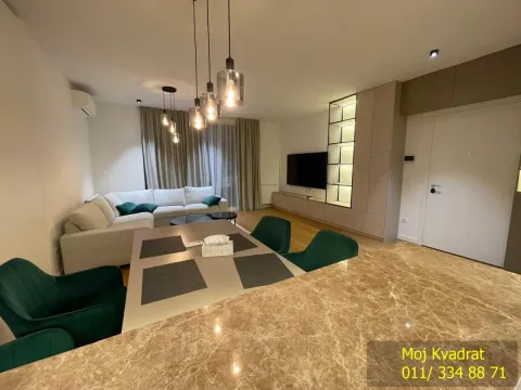 Living room with a sofa, dining table, and built-in units. - image 9