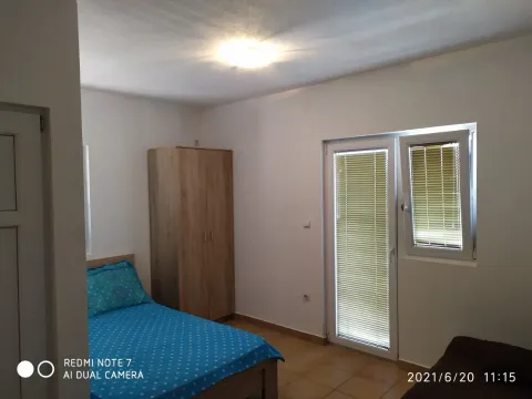 Furnished bedroom with a bed, wardrobe, and terrace access. - image 2