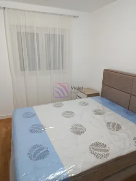 Furnished bedroom with a double bed and a window. - image 7