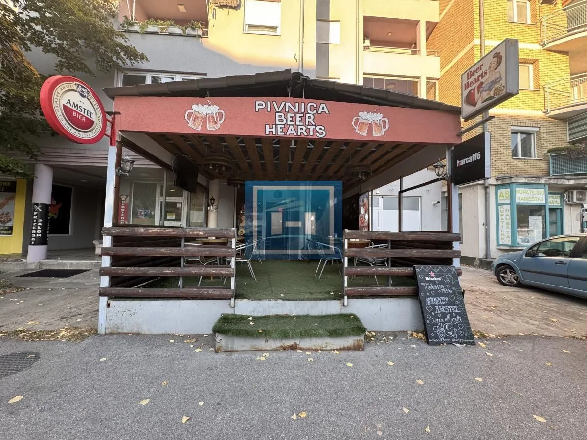 View of the exterior of the venue with the pub sign and covered terrace.