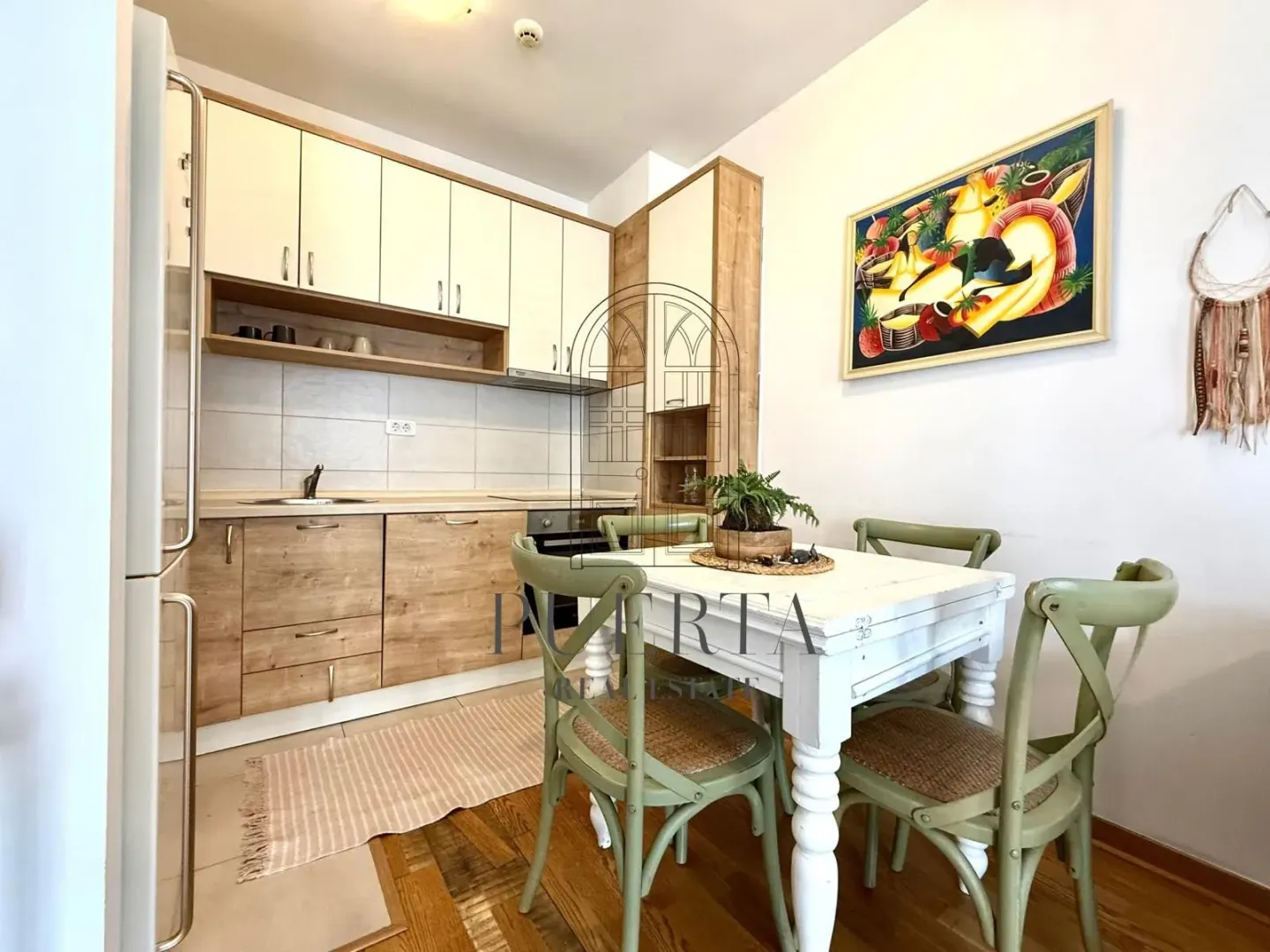 Kitchen with dining area and wooden elements.