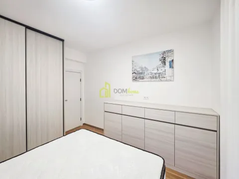 Bedroom with a bed, built-in wardrobe, and chest of drawers. - image 5