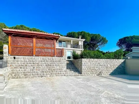 Pogled na spoljašnjost kuće sa popločanim dvorištem, kamenim zidovima i drvenom sjenicom. - image 37