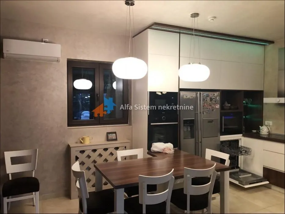 Modern kitchen with a dining table and built-in appliances.
