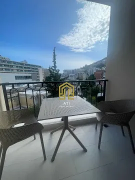 Furnished terrace with a table, chairs, and a city view. - image 2