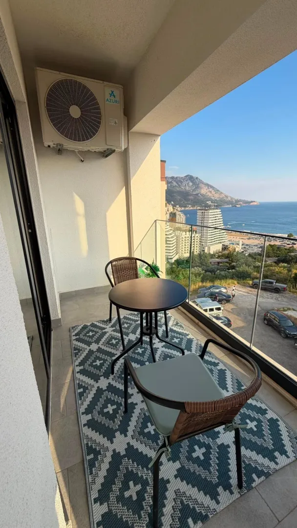 Furnished balcony with seating and sea view.