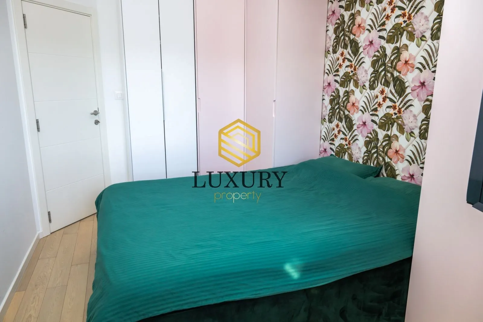 Decorated bedroom with a double bed and built-in closets.