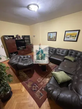 Living room with a sofa set, coffee table, and TV unit. - image 2