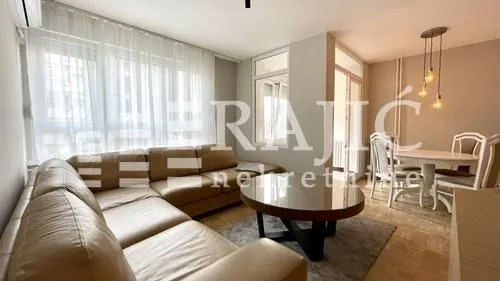 Living room with sofa and dining area.