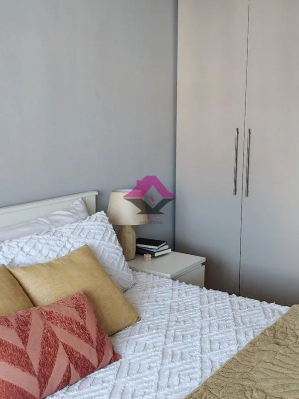 Part of the bedroom with a bed and a wardrobe.