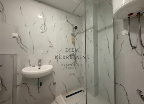 Modernly equipped bathroom with a walk-in shower and sink. - image 6