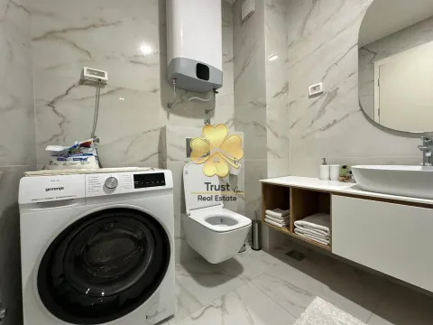 Modernly equipped bathroom with a washing machine. - image 11
