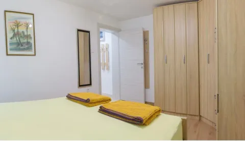Furnished bedroom with a large wardrobe and a bed. - image 9