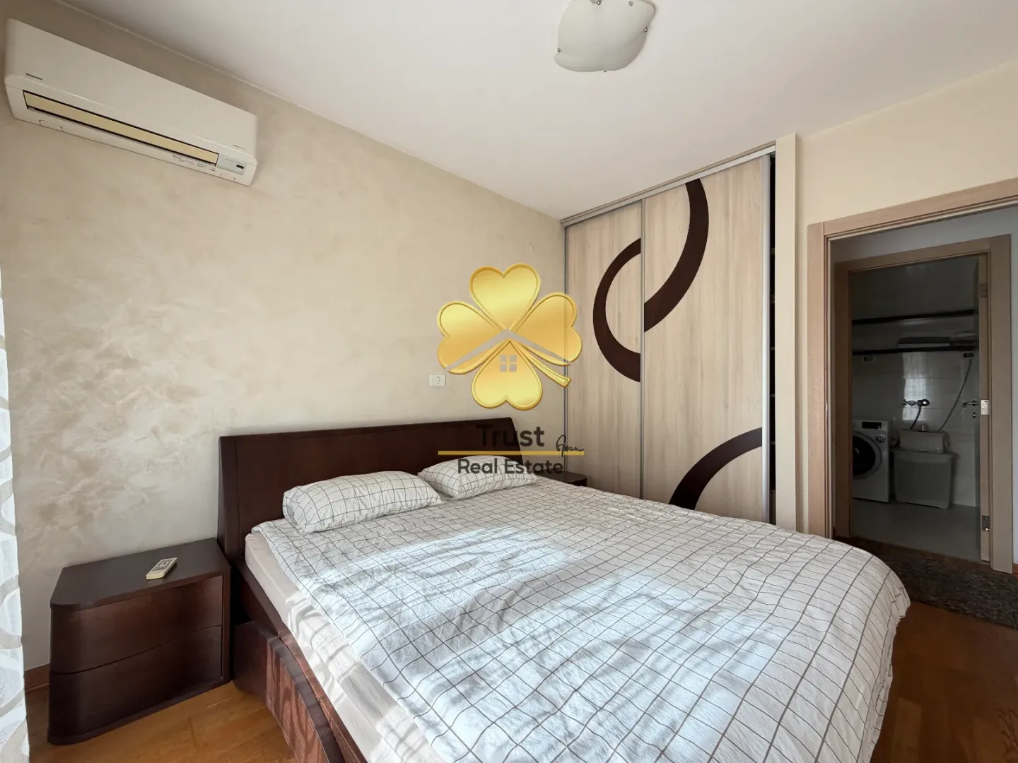 Furnished bedroom with a double bed, wardrobe, and air conditioning.
