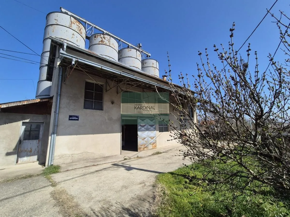 Exterior of an industrial building with silos and a courtyard.