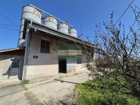 Exterior of an industrial building with silos and a courtyard. - image 5