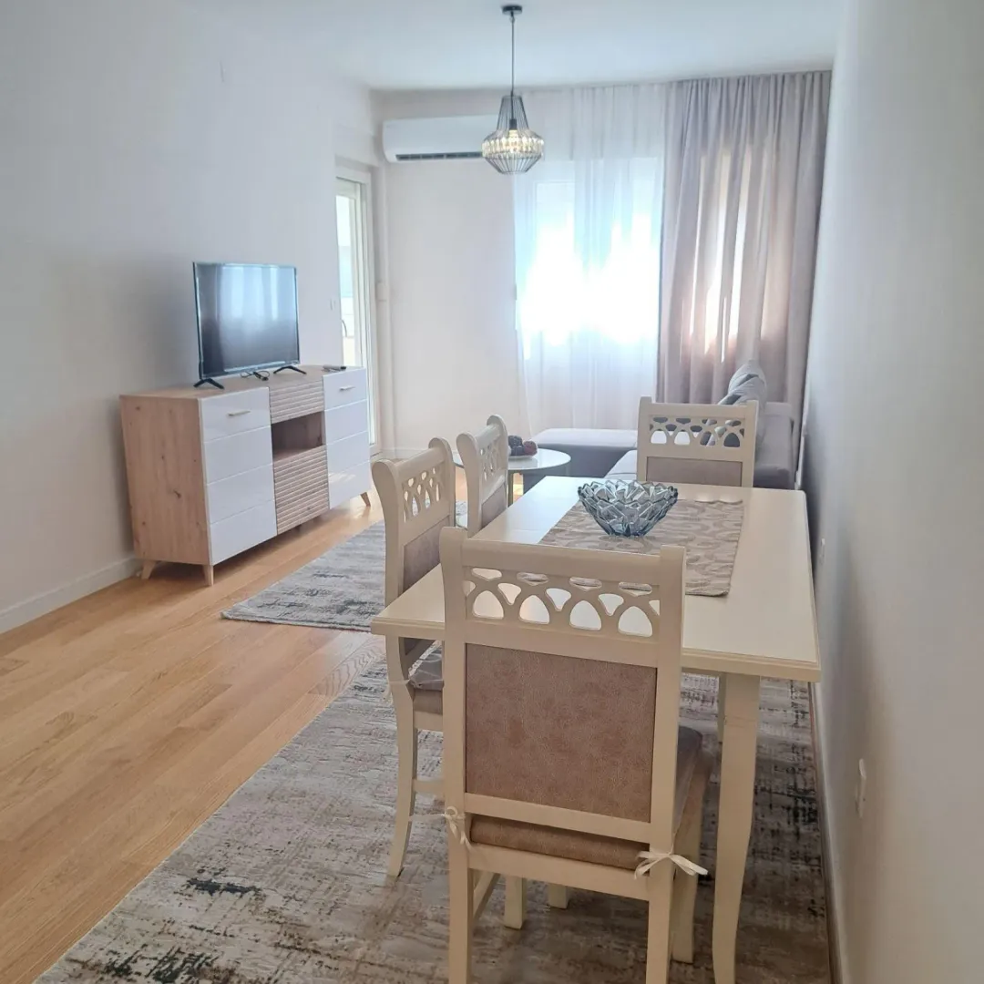 Living room with a dining table and television.