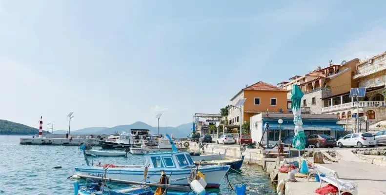 View of the harbor and coastline with boats and buildings.