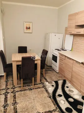 Kitchen with dining area and wooden units. - image 2