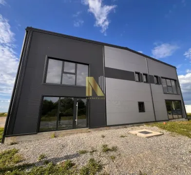 Exterior view of a modern commercial building with a dark facade and large windows. - image 2