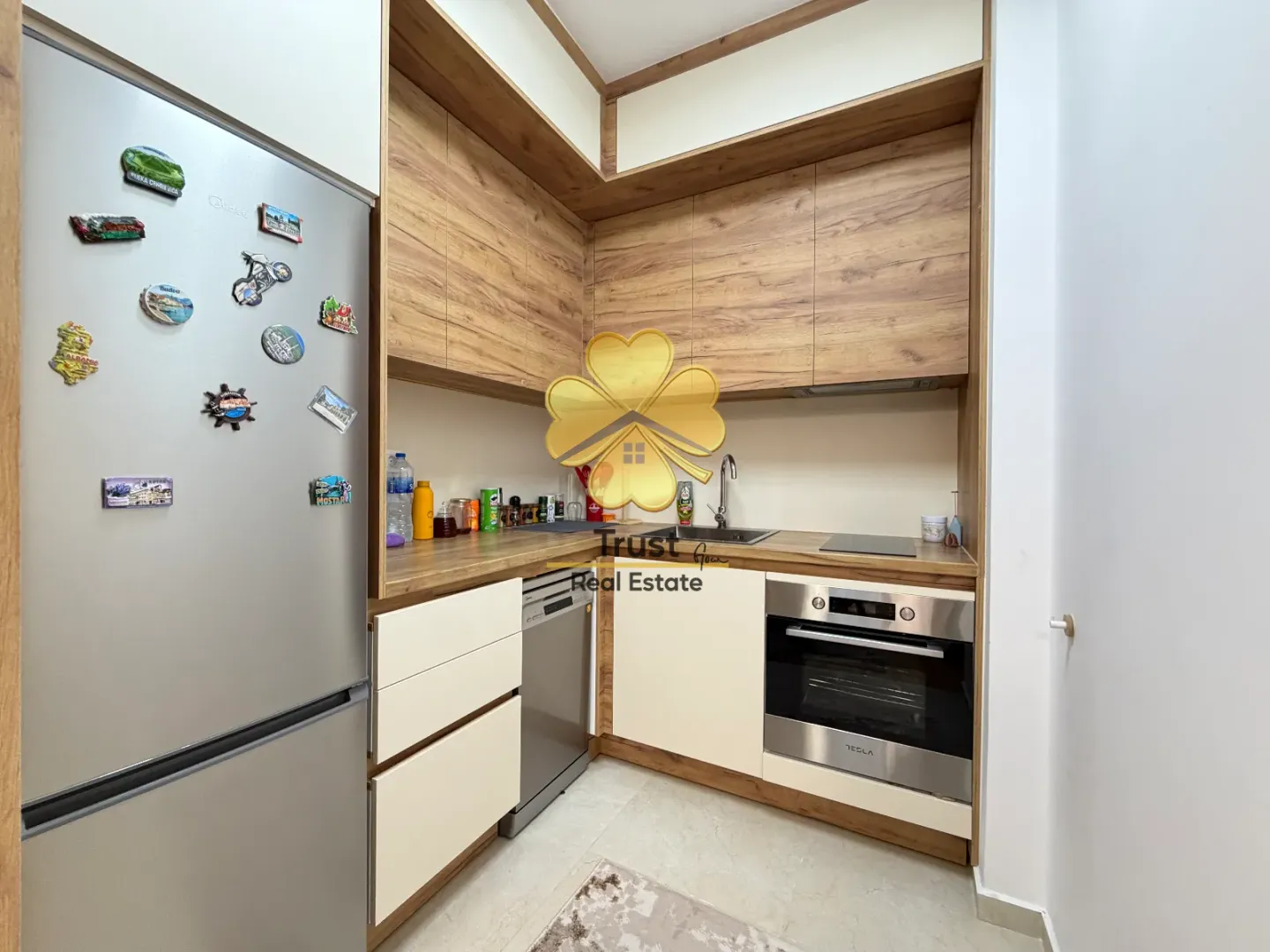 Small kitchen with wooden elements and built-in appliances.